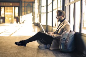 man writing on a laptop